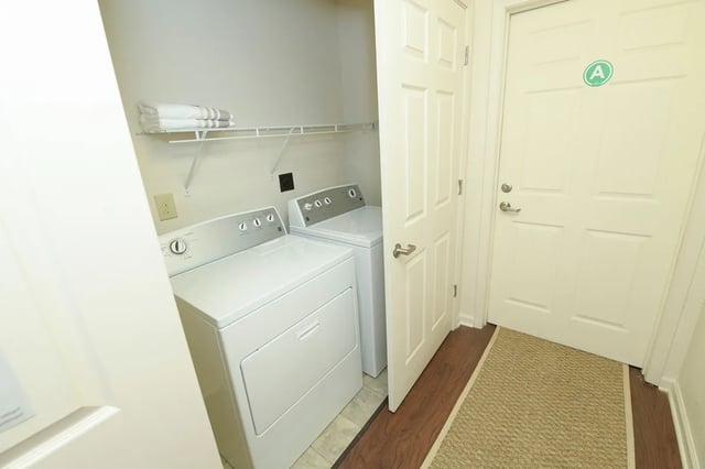 Two washers on shelf with towels laundry room at The Verge at Grand Forks in Grand Forks Student Accommodation