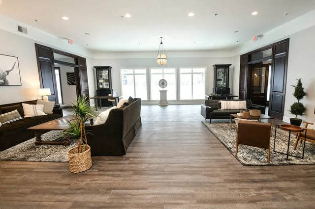 Modern lobby with sofas coffee tables and plants at The Verge at Grand Forks in Grand Forks Student Accommodation