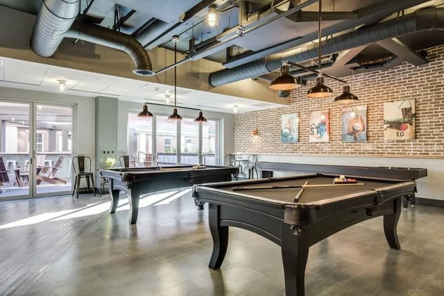 Pool tables and seating in common area game room at 12 North in College Station Student Accommodation