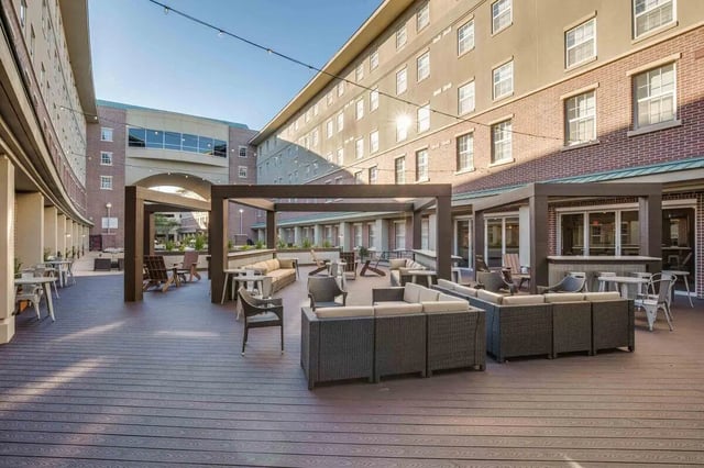 Outdoor patio with sofas tables chairs exterior at 12 North in College Station Student Accommodation