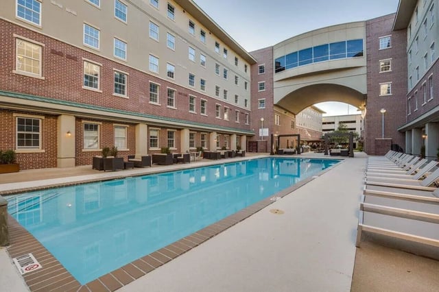 Swimming pool lounge chairs and outdoor seating exterior at 12 North in College Station Student Accommodation