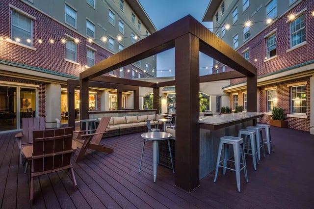 Outdoor lounge chairs bar and seating patio exterior at 12 North in College Station Student Accommodation