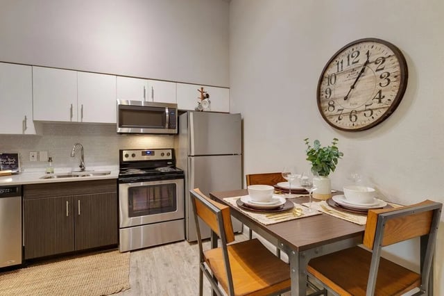 Modern kitchen with dining table and clock kitchen at 12 North in College Station Student Accommodation