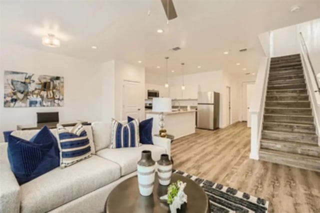 Sofa kitchen stairs art and refrigerator living room at BelCara Luxury Townhomes in San Antonio Student Accommodation