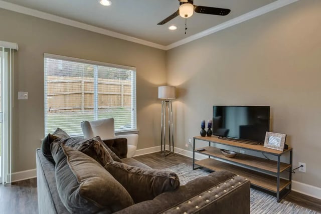 Sofa TV and window living room at BelCara Luxury Townhomes in San Antonio Student Accommodation