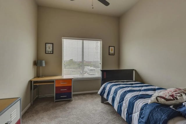 Bed desk lamp colorful drawers window bedroom at BelCara Luxury Townhomes in San Antonio Student Accommodation