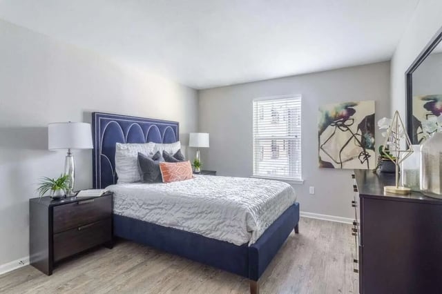 Blue bed with white bedding dark nightstand bedroom at Bridge at Cameron in Austin Student Accommodation
