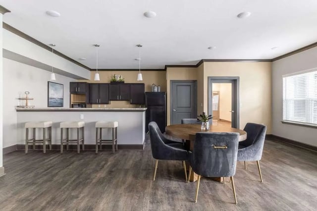 Bar kitchen stools round table chairs living area at Bridge at Cameron in Austin Student Accommodation