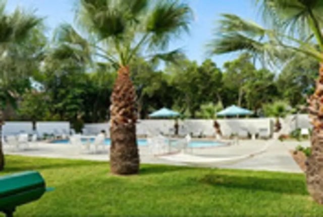 Pool area with lounge chairs and hammocks exterior at Establishment in Austin Student Accommodation