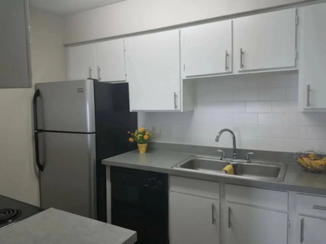 Stainless steel refrigerator dual sink cabinets kitchen at Establishment in Austin Student Accommodation