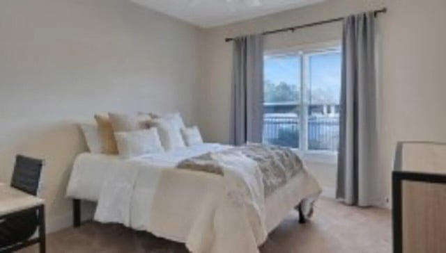 Bed desk chair window curtains bedroom at The Cottages at Lake Tamaha in Tuscaloosa Student Accommodation