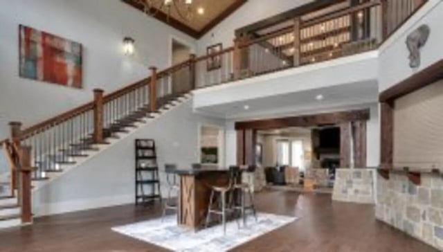 Bar with stools staircase and abstract art living room at The Cottages at Lake Tamaha in Tuscaloosa Student Accommodation