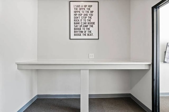 White desk with framed wall art study area at Central House on Stadium in Mobile Student Accommodation