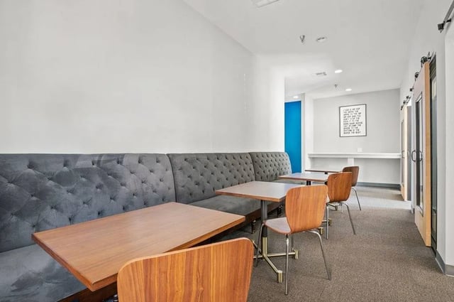 Tufted grey sofa tables and chairs communal area at Central House on Stadium in Mobile Student Accommodation