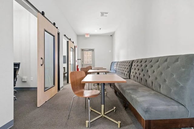 Tufted grey bench and tables study area at Central House on Stadium in Mobile Student Accommodation