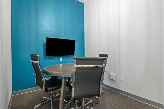 Round table four chairs flat screen TV study area at Central House on Stadium in Mobile Student Accommodation
