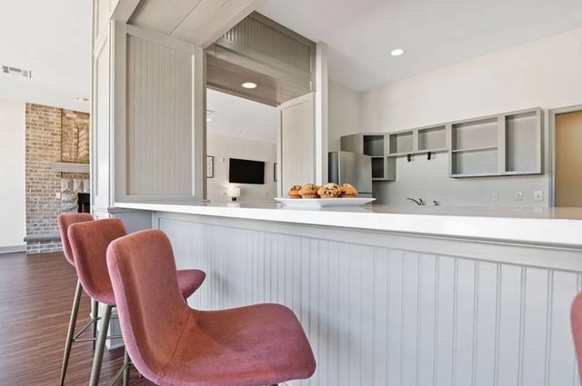 Three pink bar stools and muffins communal area at Central House on Stadium in Mobile Student Accommodation