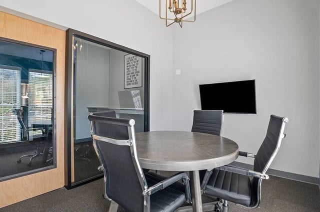 Round table four chairs and TV study area at Central House on Stadium in Mobile Student Accommodation