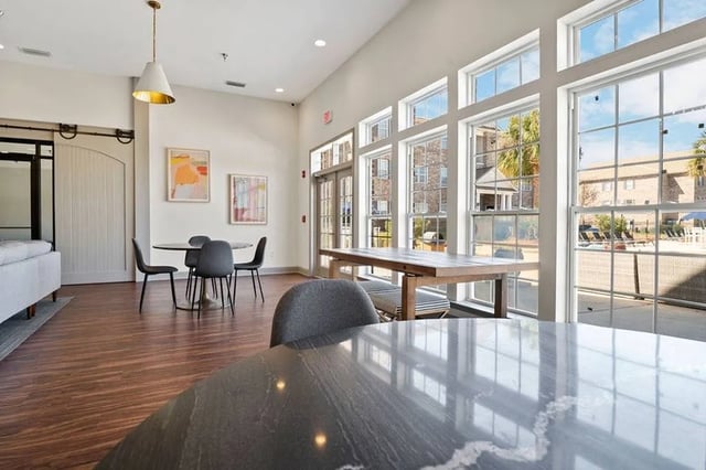 Dining tables chairs artwork large windows common area at Central House on Stadium in Mobile Student Accommodation