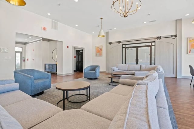 Sofas chairs and coffee tables in lounge living room at Central House on Stadium in Mobile Student Accommodation