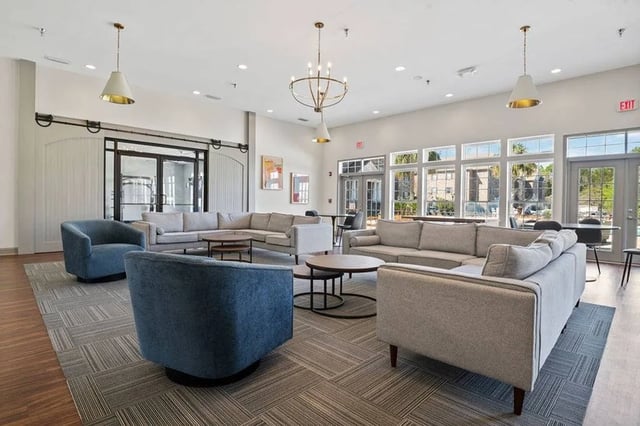 Large sectional sofas armchairs coffee tables living room at Central House on Stadium in Mobile Student Accommodation