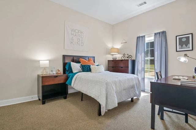 Bed nightstand dresser desk artwork bedroom at Central House on Stadium in Mobile Student Accommodation