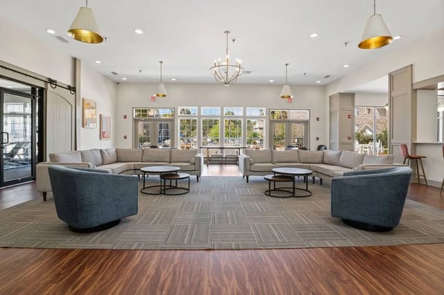 Large sectional sofas, accent chairs, coffee tables, common area at Central House on Stadium in Mobile Student Accommodation