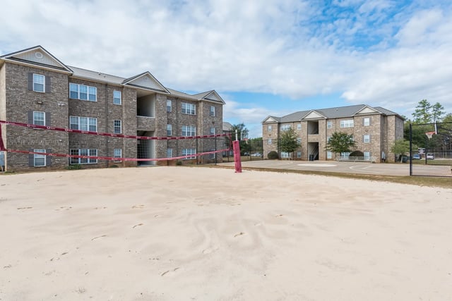 Apartment buildings with volleyball net playing area at Central House on Stadium in Mobile Student Accommodation