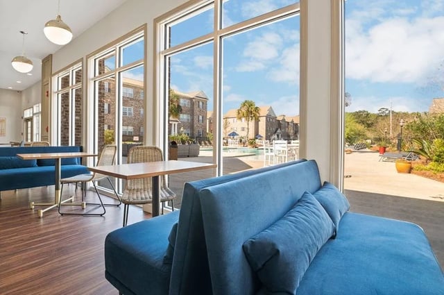Blue sofas tables and chairs common area at Central House on Stadium in Mobile Student Accommodation