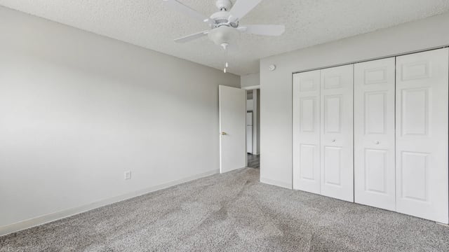 White closet doors ceiling fan open door bedroom at Wind River Place Apartments in Colorado Springs Student Accommodation