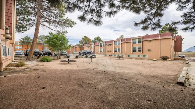 Apartment buildings with parking and picnic tables exterior at Wind River Place Apartments in Colorado Springs Student Accommodation
