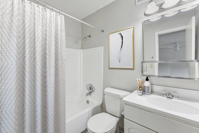 Bathroom with toilet sink bathtub and framed art at Wind River Place Apartments in Colorado Springs Student Accommodation