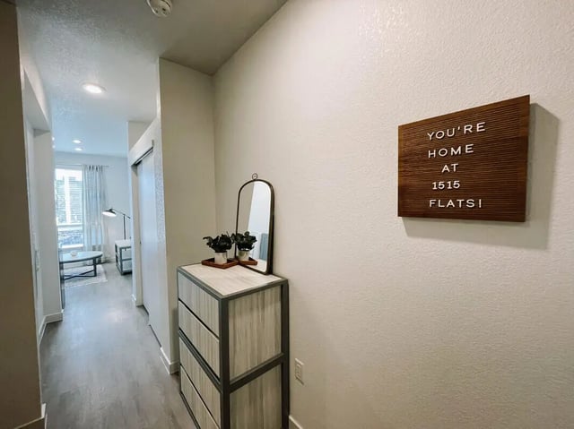 Hallway dresser mirror plants sign living area interior at 1515 Flats in Denver Student Accommodation