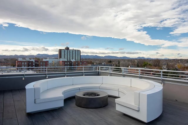 Curved white sofa with fire pit outdoor seating area at 1515 Flats in Denver Student Accommodation