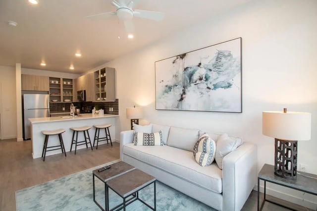 Sofa kitchen island bar stools abstract painting living room at 1515 Flats in Denver Student Accommodation