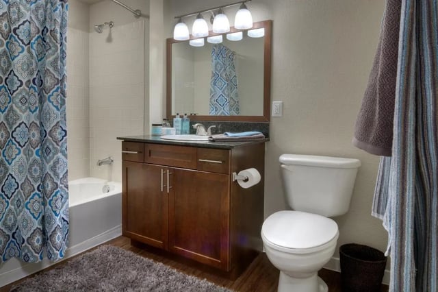 Bathtub vanity toilet and shower curtain bathroom at Uptown Broadway in Boulder Student Accommodation