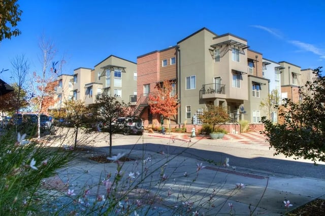 Apartment buildings balconies cars landscaping exterior at Uptown Broadway in Boulder Student Accommodation