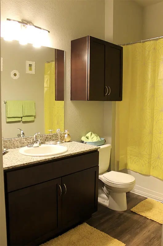 Vanity toilet shower curtain yellow towels bathroom at The Knox in Knoxville Student Accommodation