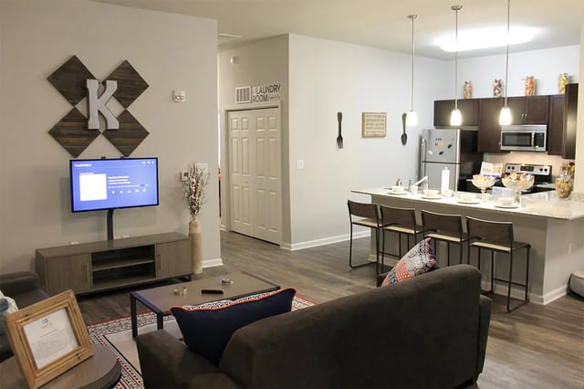 Living room with TV kitchen and island Living Room at The Knox in Knoxville Student Accommodation