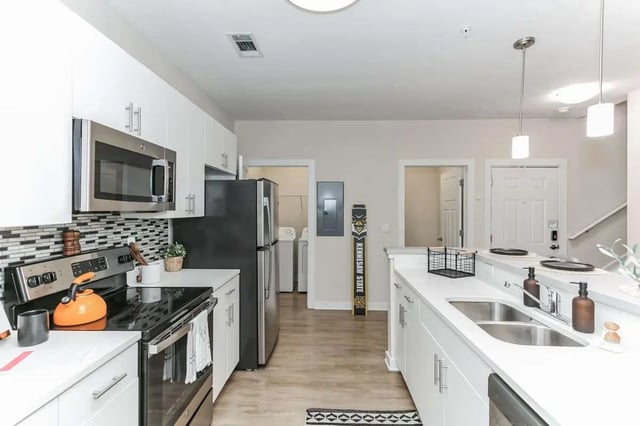 Stainless steel appliances white cabinets and countertops kitchen at Copper Social in Marietta Student Accommodation