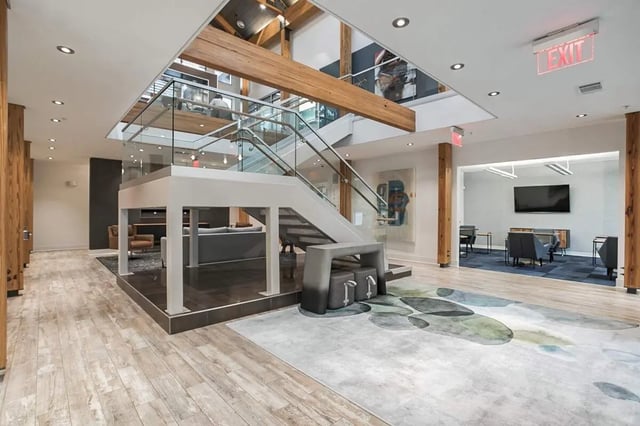 Staircase glass railing artwork modern lobby living room at Copper Social in Marietta Student Accommodation