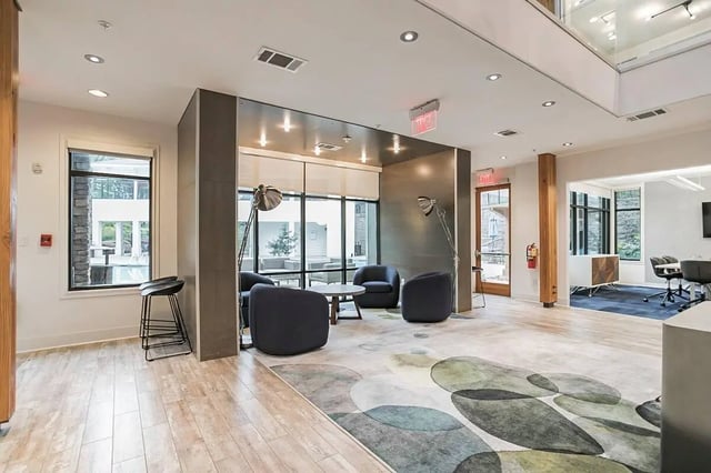 Modern lounge with armchairs coffee table living room at Copper Social in Marietta Student Accommodation
