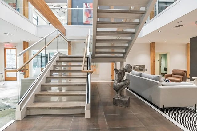Modern staircase, couch, sculpture, common area at Copper Social in Marietta Student Accommodation