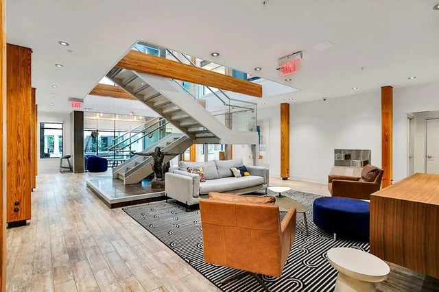 Sofa chairs staircase sculpture modern common area at Copper Social in Marietta Student Accommodation