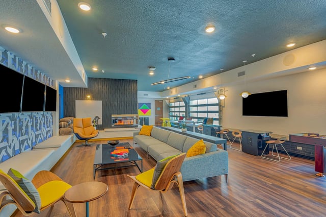 Sofas fireplace and TVs communal living room living room at Alsander GNV in Gainesville Student Accommodation