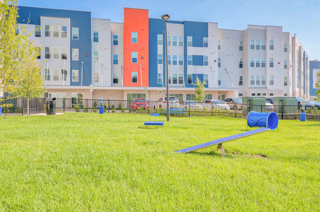 Modern apartment building dog park exterior at Alsander GNV in Gainesville Student Accommodation