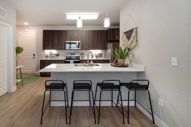 Four black bar stools at kitchen island kitchen at Alsander GNV in Gainesville Student Accommodation