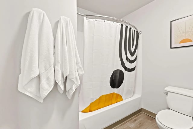 White towels shower curtain toilet bathroom at Auraria Student Loft in Denver Student Accommodation