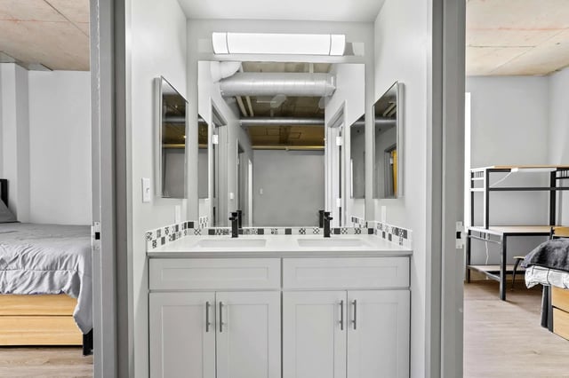 Double vanity with mirrors and tiled backsplash bathroom at Auraria Student Loft in Denver Student Accommodation
