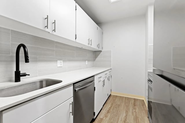 White cabinets sink faucet dishwasher kitchen at Auraria Student Loft in Denver Student Accommodation